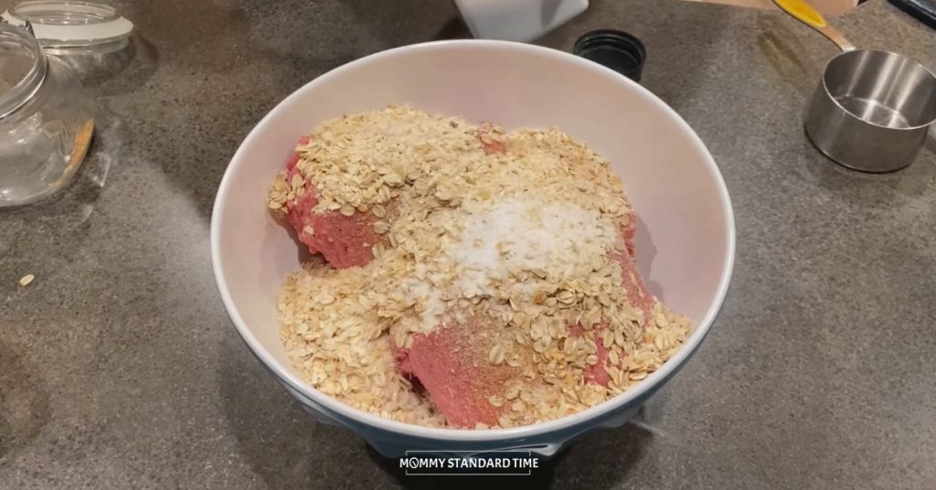 The ingredients for meatballs and meatloaf in a mixing bowl