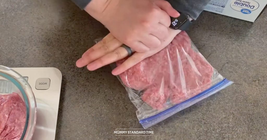 Pushing on a bag Ziploc bag of ground beef to make it flat